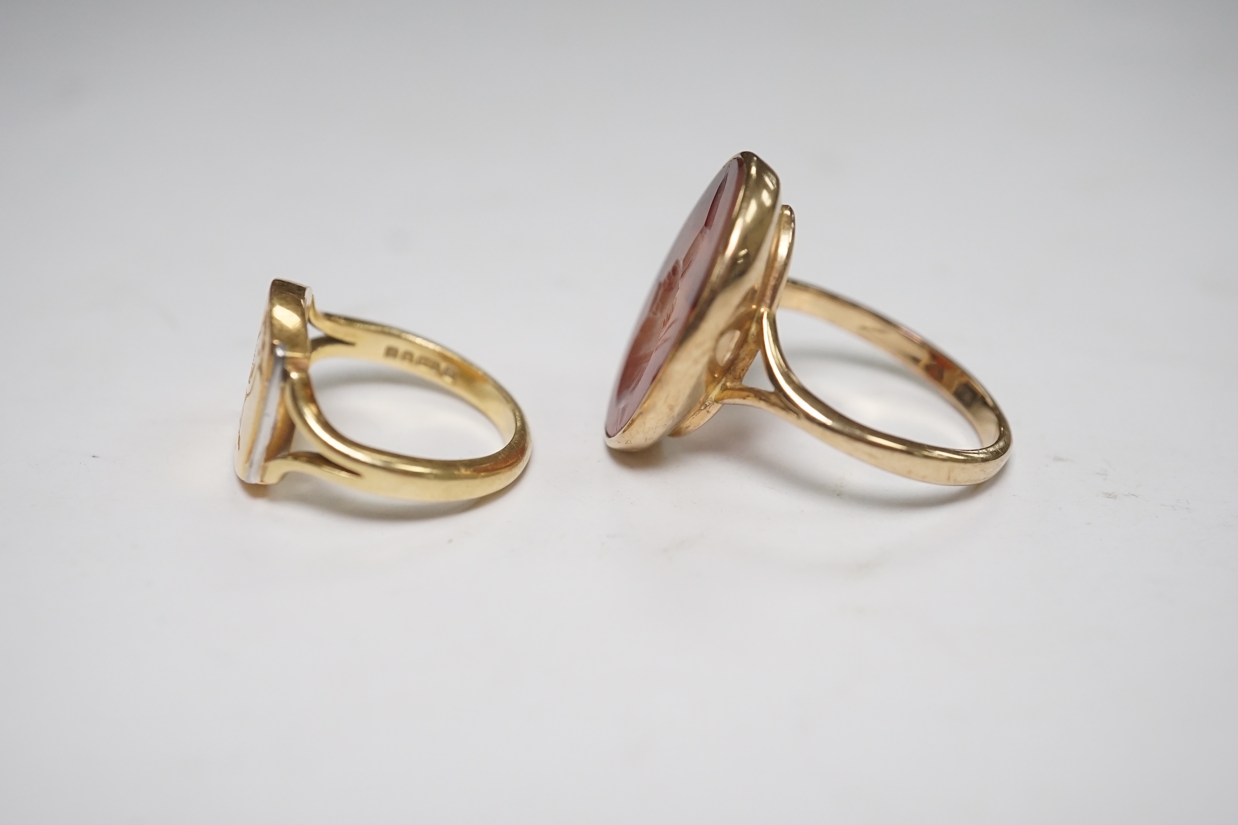 A yellow metal and intaglio agate set oval ring, size P, together with a modern 18ct gold signet ring, engraved with a bird, gross weight 12.3 grams. Condition - poor to fair